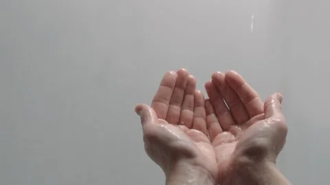 Hands reaching out praying in rain on white background Stock Footage 88050405
