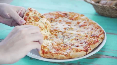 Hands reaching for pizza slice restaurant tasty fresh cuisine eat dinner Video stock 336586752