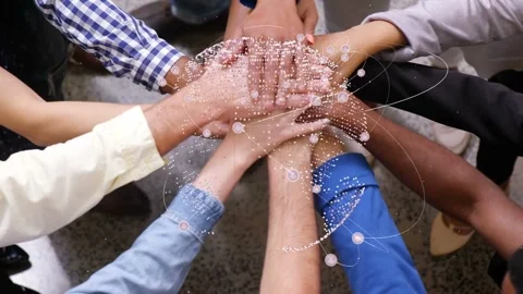 Hands reaching in, team stacking hands and pressing while globe particles orbit, 库存影片 337912948