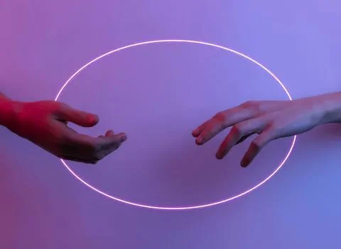 Hands reaching towards each other with glowing circle Stock Photos