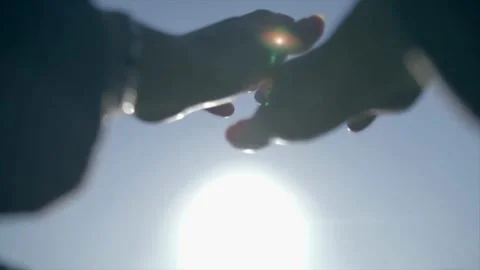 Hands reaching towards the sun in a bright sky Stock Footage 341314952