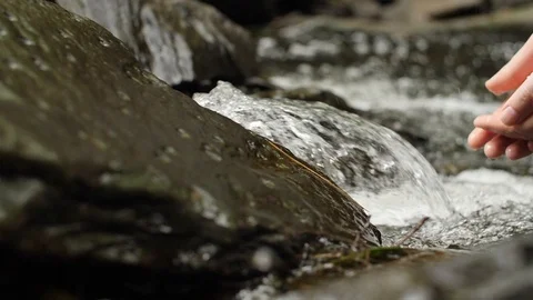 Hands reaching into a waterfall - Slowmotion #3 Stock Footage 90626992