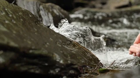 Hands reaching into a waterfall - Slowmotion Stock Footage 90626855