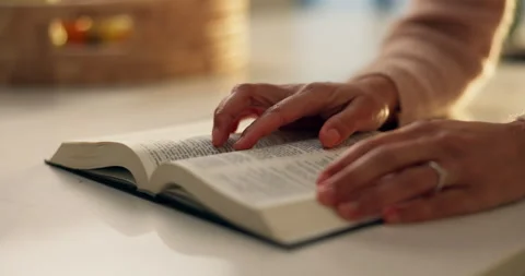 Hands, reading and bible study in home, faith and scripture review for spiritual Stock Footage 312875905