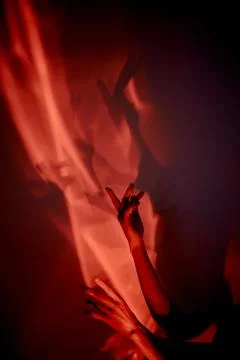 Hands in red light. Abstraction. Shadow theatre, hallucinations. Foto stock