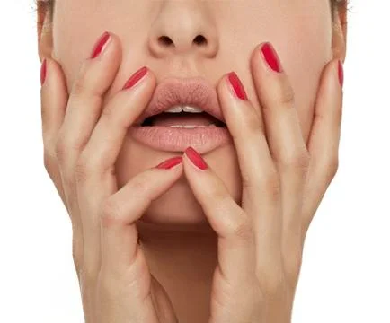 HANDS WITH RED NAILS ON FACE Stock Photos
