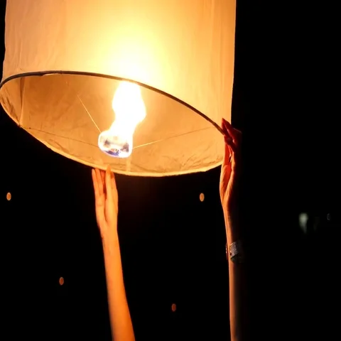 Hands Releasing Floating Lantern at Yee ... | Stock Video | Pond5