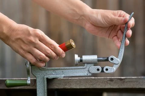Hands reloading cartridge by shotgun shell reloader Stock Photos