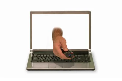 Hands with remote control reaching out of laptop display Foto stock