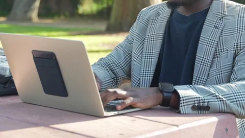 Hands of a Remote Worker on Laptop in a Calm Outdoor Setting. Stock Footage 308614531