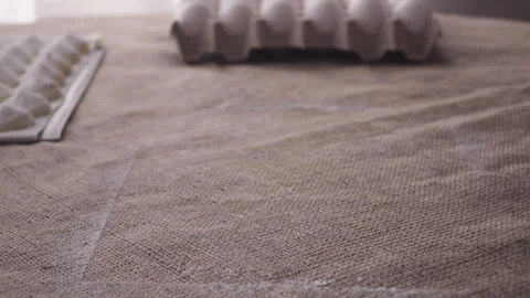 Hands remove tray of powdered sugar candies from rustic table Stock Footage 240578490