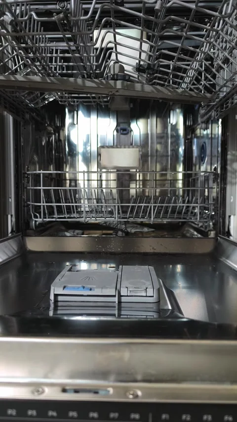 Hands removing clean cups from open upper dishwasher rack in kitchen. Perso.. Stock Footage 344892055