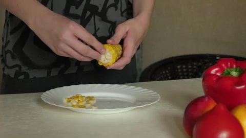 Hands removing corn kernels in home Stock Footage 322073953