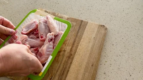 Hands Removing Liquid Absorption Pad From Raw Chicken Wing Packaging Stock Footage 339513374