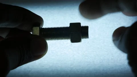 Hands Removing Metal Hex Nut from Threaded Bolt Stock Footage 340070158