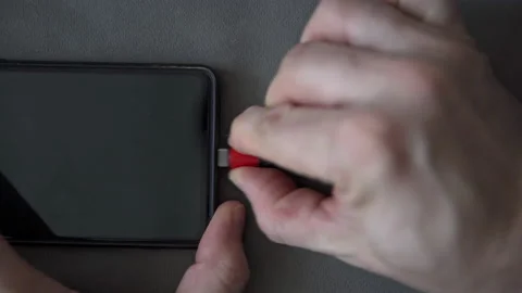 Hands removing micro usb plug from cell phone socket Vídeo Stock 237776229