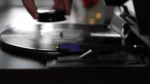 Hands Removing a Vinyl Record from a Turntable Stock Footage 333757195