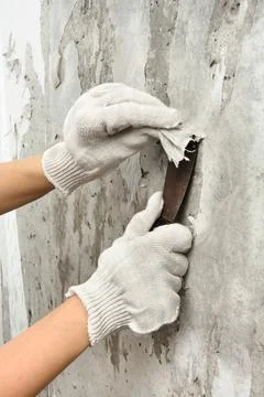 Hands removing wallpaper from wall Stock Photos