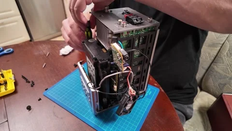 Hands repairing an electronic device with exposed circuit boards Stock-Footage 309914503