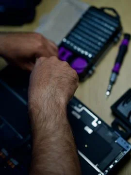 Hands Repairing an Opened Laptop Computer With Precision Tools Stock Photos