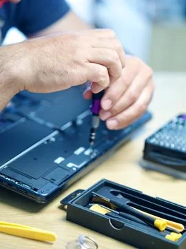 Hands Repairing an Opened Laptop Computer With Precision Tools Stock Photos
