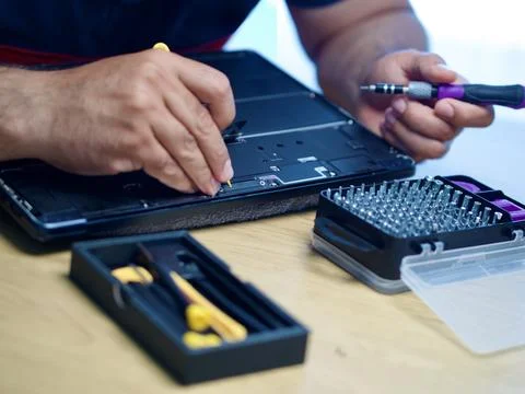 Hands Repairing an Opened Laptop Computer With Precision Tools Stock Photos