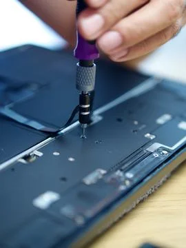 Hands Repairing an Opened Laptop Computer With Precision Tools Stock Photos