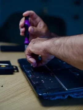 Hands Repairing an Opened Laptop Computer With Precision Tools Stock Photos