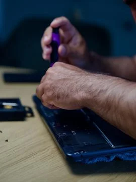 Hands Repairing an Opened Laptop Computer With Precision Tools Stock Photos