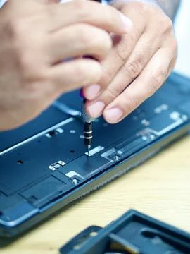 Hands Repairing an Opened Laptop Computer With Precision Tools Stock Photos