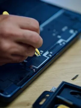 Hands Repairing an Opened Laptop Computer With Precision Tools Stock Photos