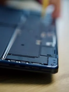 Hands Repairing an Opened Laptop Computer With Precision Tools Stock Photos