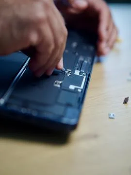 Hands Repairing an Opened Laptop Computer With Precision Tools Stock Photos