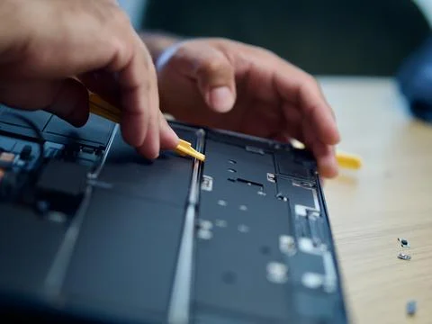 Hands Repairing an Opened Laptop Computer With Precision Tools Stock Photos