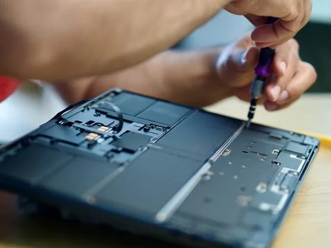 Hands Repairing an Opened Laptop Computer With Precision Tools Stock Photos
