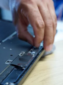 Hands Repairing an Opened Laptop Computer With Precision Tools Stock Photos