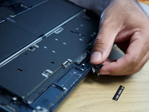 Hands Repairing an Opened Laptop Computer With Precision Tools Stock Photos