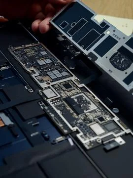 Hands Repairing an Opened Laptop Computer With Precision Tools Stock Photos