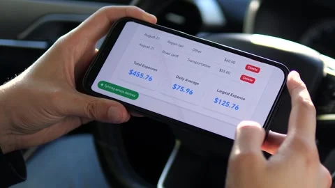 Hands rest pensively on a phone displaying travel expenditure details Stock Footage 316765927