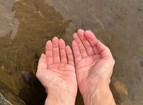 Hands in River Water Stock Photos