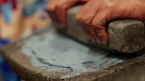 Hands Roll and Turn Rectangular Stone to Spread Green Tortilla Dough and Scoop Stock Footage 339952065