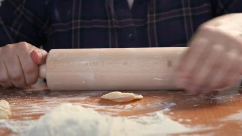 Hands roll out dough on flour scattered on table Baking by chef, making dumpling Video stock 242053515