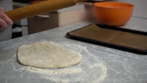 Hands roll out the dough with a rolling pin Stock Footage 120295139