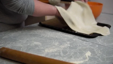 Hands roll out the dough with a rolling pin Stock Footage 122762368