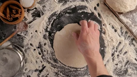 Hands roll out the dough with a rolling pin Video stock 130532518