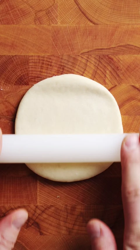 Hands roll pizza dough with plastic pin on board. Stock Footage 341429727