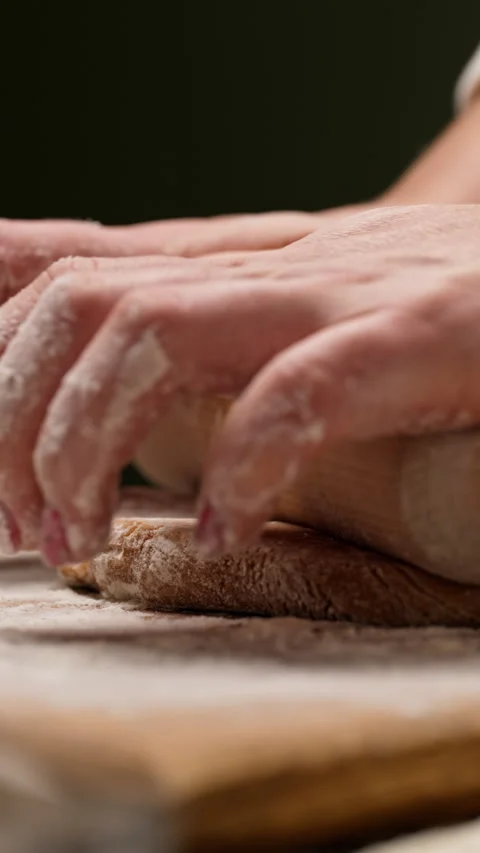 Hands rolling dough with a rolling pin 動画素材 320835476