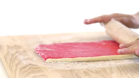 Hands with a rolling pin roll the dough for croissants Stock Footage 89385636