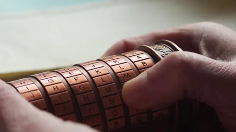 Hands Rotating Cryptex Puzzle, Tense Code Breaking and Secret Unlock Attempt Stock Footage 334360153