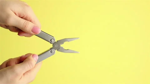 Hands in rubber gloves holding pliers on yellow background copy space 스톡 동영상 148422053